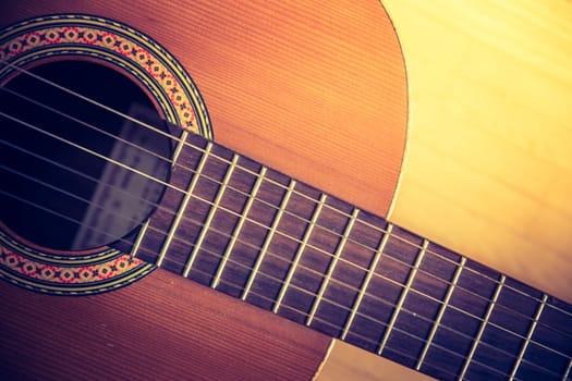 Cutout of a classical guitar corpus and strings, closeup