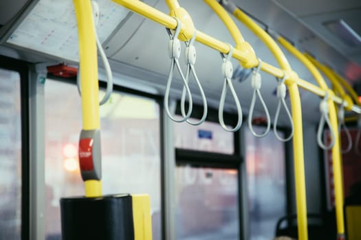 Hold on straps in a bus, commuting, public transport