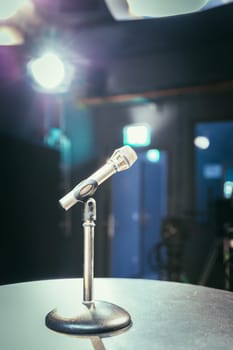 Metal microphone in the studio, studio lights in the blurry background