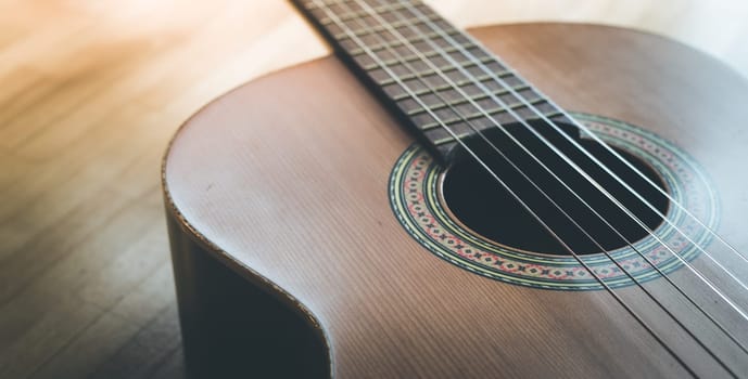 Cutout of a classical guitar corpus and strings, closeup