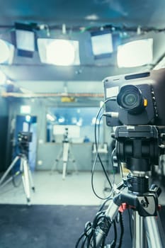 Film camera on a tripod in a television broadcasting studio