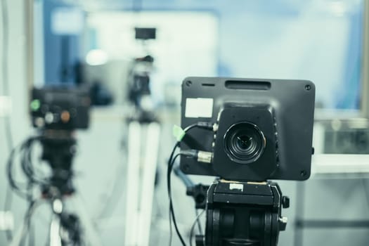 Lens of a film camera in an television broadcasting studio, spotlights and equipment