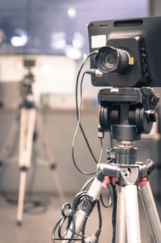 Film camera on a tripod in a television broadcasting studio