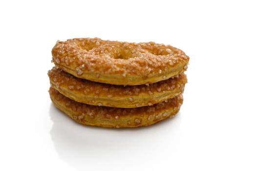 Three golden pastries piled high, glittering with sugar, inviting an indulgent treat for sweet lovers.