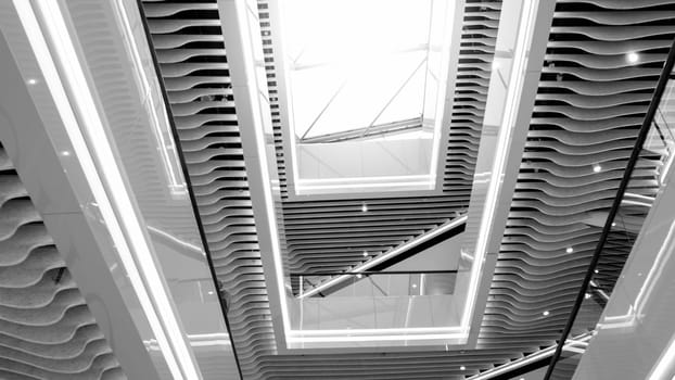 Black and white abstract architecture image of glass roof in modern office building.