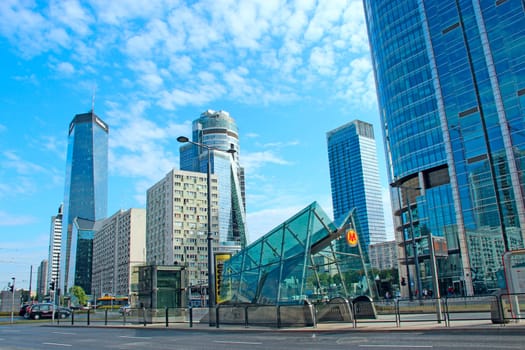 Tall glass skyscrapers in Warsaw. Modern architecture of city buildings. Business center with modern buildings in Warsaw. Skyscrapers in city. Road in modern city. roadway in city. City life