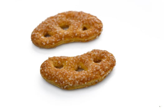 Delightful sugar-coated pretzels resting on a smooth surface, inviting taste buds with their unique shape.