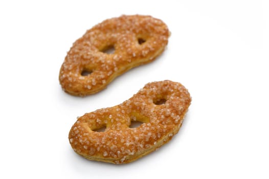 Delightful pastries shaped like infinity symbols, adorned with sparkling sugar, await at a local bakery's display.