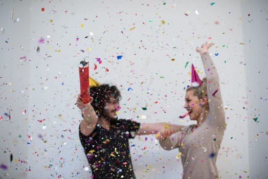 young romantic  couple in love  celebrating and blowing confetti decorations