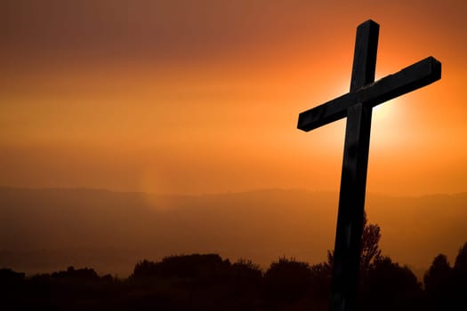 cross silhouette with the sunset as background
