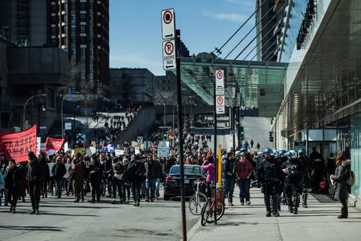 MONTREAL, CANADA, APRIL 02 2015. Riot in the Montreal Streets to counter the Economic Austerity Measures. Cops Following Marchers in case of something Goes Wrong