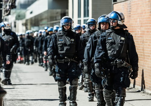 MONTREAL, CANADA, APRIL 02 2015. Riot in the Montreal Streets to counter the Economic Austerity Measures. Cops Following Marchers in case of something Goes Wrong