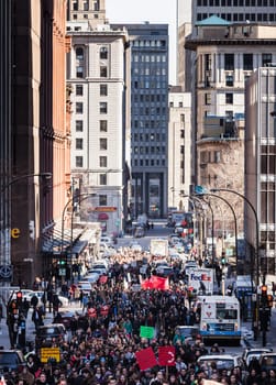 MONTREAL, CANADA, APRIL 02 2015. Riot in the Montreal Streets to counter the Economic Austerity Measures. People walking in the middle of the street.