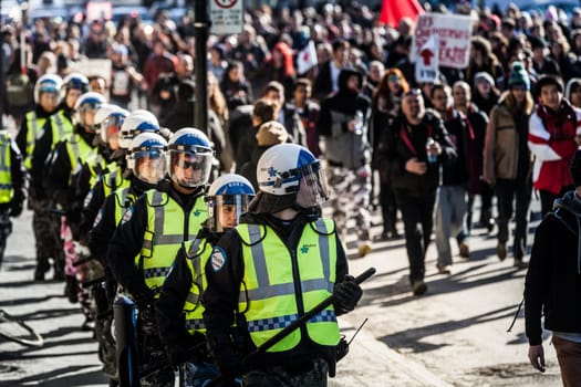 MONTREAL, CANADA, APRIL 02 2015. Riot in the Montreal Streets to counter the Economic Austerity Measures. Cops Following the Marchers to make sure everything is under Control