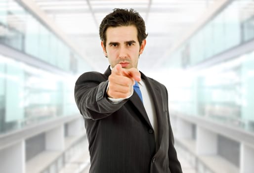 young business man in a suit pointing at the office