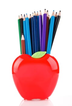 color pencils in red apple shaped stand isolated on white