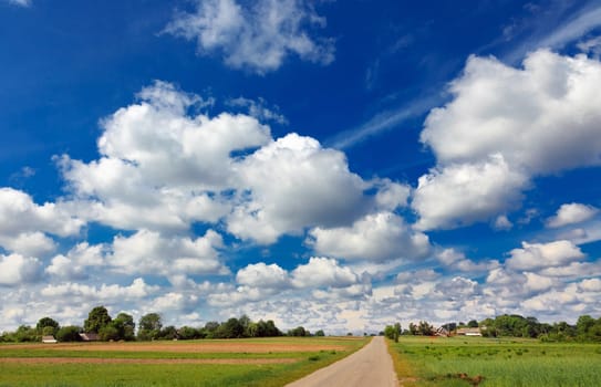 village landscape with road and incredible clouds