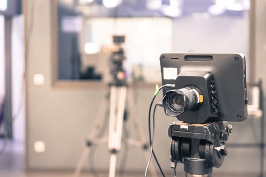 Film camera on a tripod in a television broadcasting studio