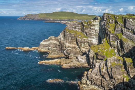 Rugged coastline with majestic tall Kerry Cliffs and turquoise coloured Atlantic Ocean on a sunny summer day, Portmagee, Ring of Kerry, Ireland