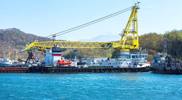 vessel with a crane at the port in Kamchatka