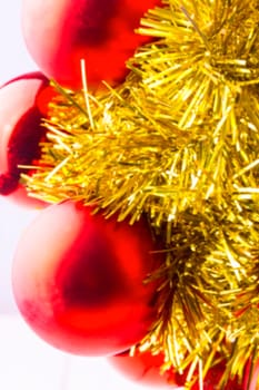 blurred background red Christmas balls and shiny ornaments on the white