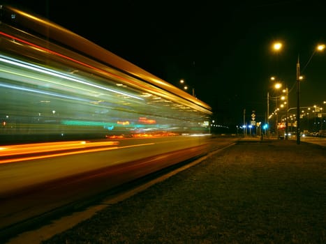 night tram red light trails motion blur passing by