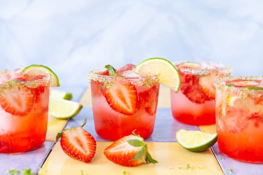Ice cold cocktail with fresh strawberries and lime