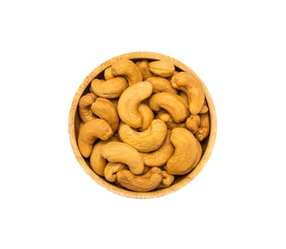 Roasted cashew nuts in brown wooden bowl isolated on white background, top view. Healthy organic super food concept