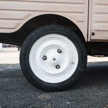 Vintage car white wheel detail shot, retro utilitarian vehicle