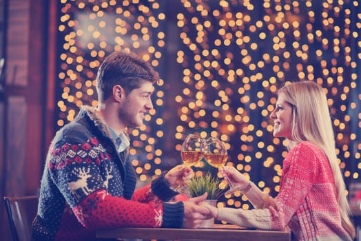 romantic evening date in restaurant  happy young couple with wine glass tea and cake
