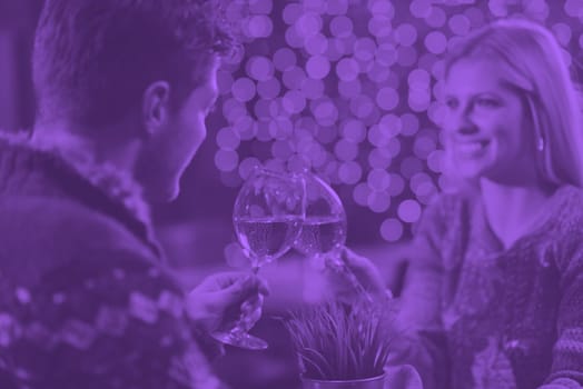 romantic evening date in restaurant  happy young couple with wine glass tea and cake duo tone