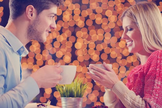 romantic evening date in restaurant  happy young couple with wine glass tea and cake