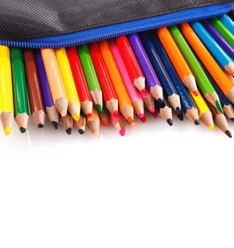 color pencils in pencil case on white background, place for text, copyspace