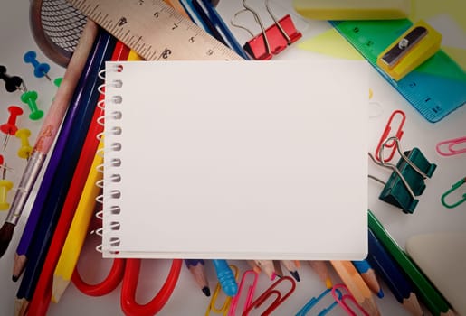 school supplies and notebook with blank sheet