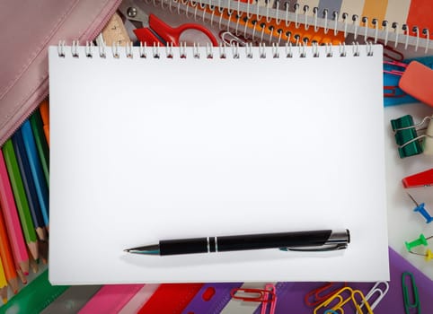Notebook with stationary objects and pen, copyspace