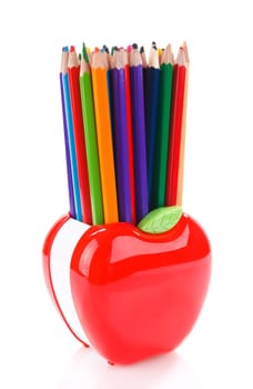 Colorful pencils in red apple shaped holder isolated on white