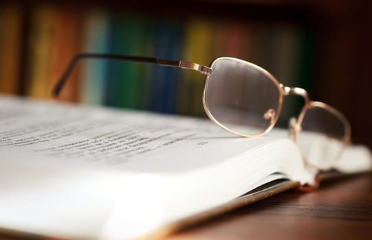 glasses and book on background bookcase