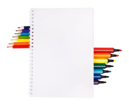 notebook with colored pencils and markers on white background with space for text