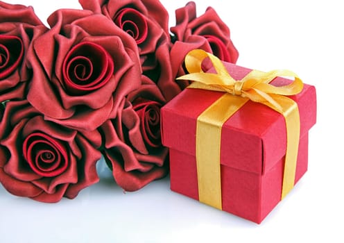 red flowers and red gift box with yellow ribbon on white background
