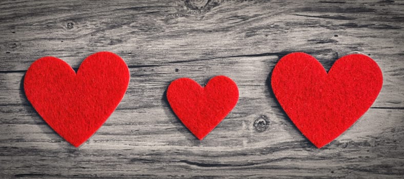 red hearts on a wooden surface