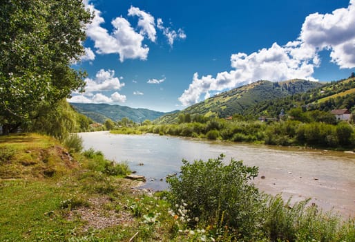 Mountain landscape with river and clouds