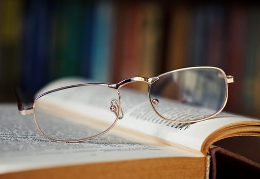 glasses and book in the library