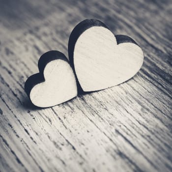 two hearts on a wooden surface