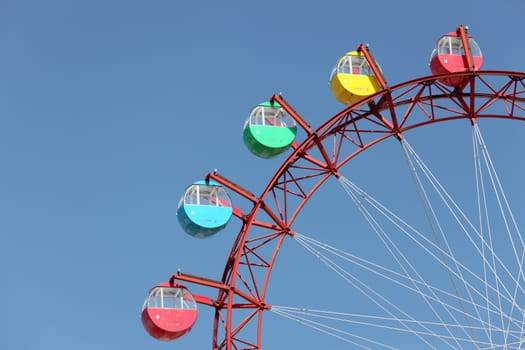 Ferris wheel against a clear blue sky