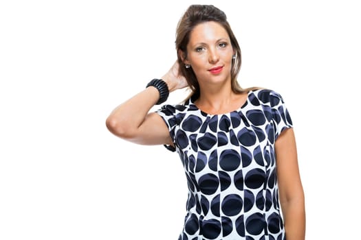 attractive smiling young woman with arms in the hip in elegant dress isolated against white background
