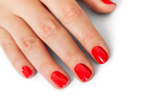 Women's hands with beautiful well-groomed fingers and red nail polish wellness beauty spa close up isolated on white background