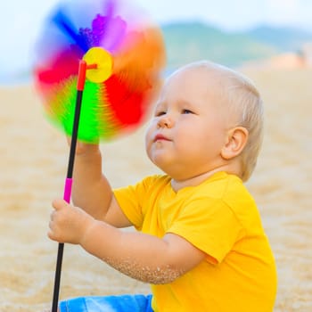 Baby playing with toy windmill