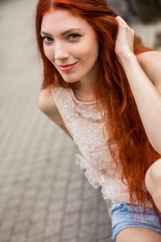 Attractive young woman with long root hair and straw hat outdoors in spring summer in blue sky