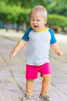 Baby walking along the beach