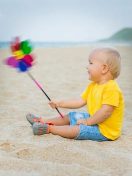 Baby playing with toy windmill